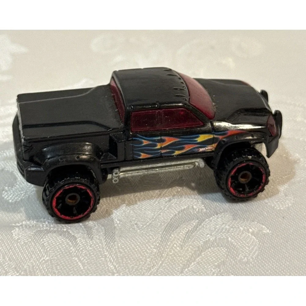 Hot Wheels Mega Duty black pickup truck, specifically the 2010 Heat Fleet